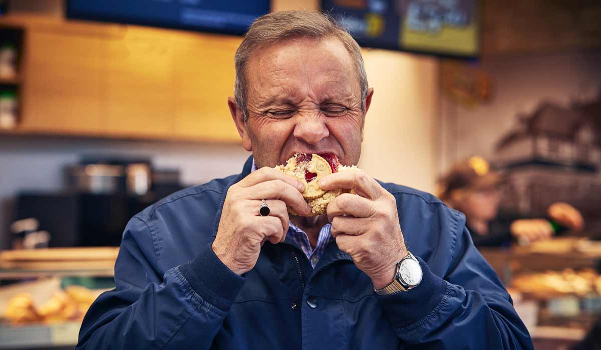 Man enjoting a Jammy D Doughnut at Bakery 79